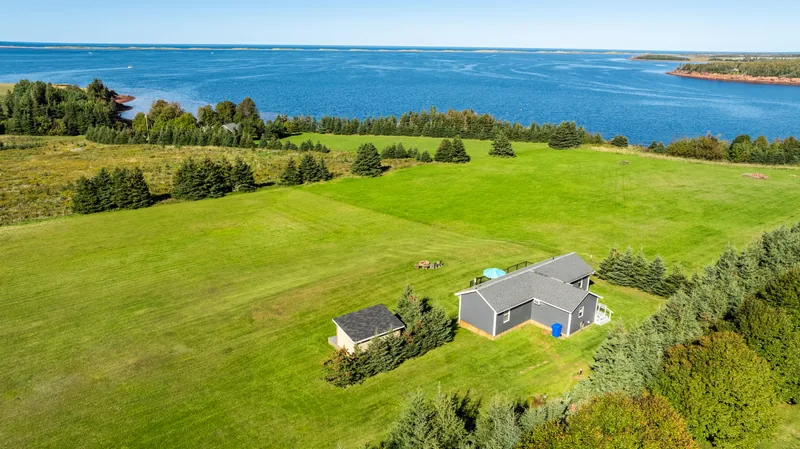 Aerial view of the cottage, lawn and waterfront