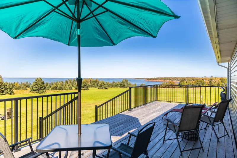 Deck with umbrella and waterfront view