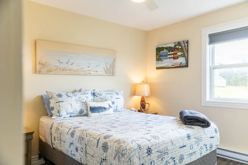 Bedroom with floral bedding and bedside lamp