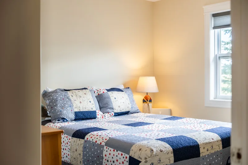 Bedroom with blue and white bedding