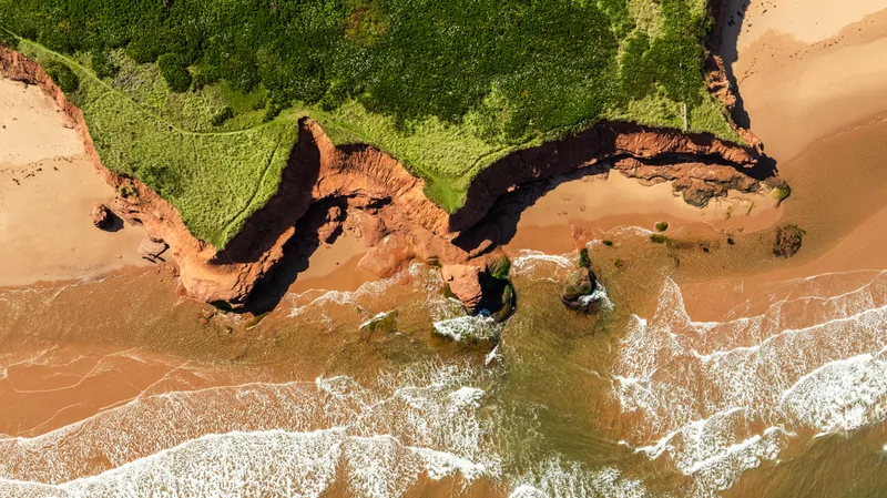 Nearby red-cliff coast aerial, separate from the cottage