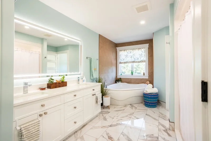 Ensuite bathroom with double vanity and bath