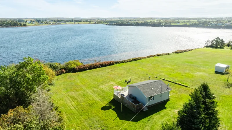 Aerial view of the cottage and waterfront lawn