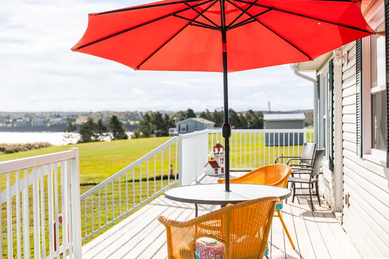 Deck table beneath a red umbrella